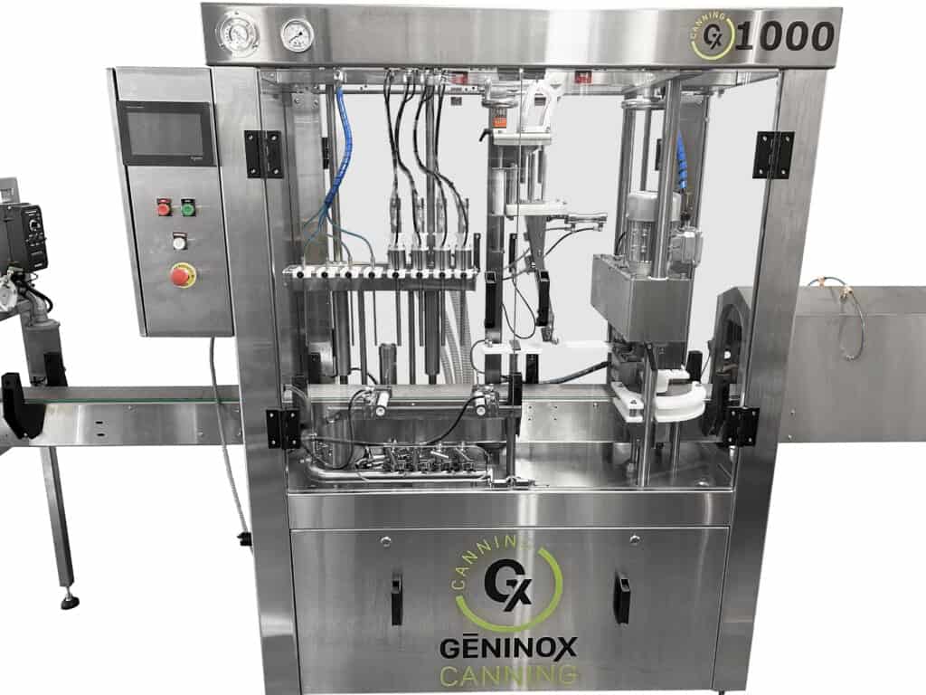 Compact atmospheric canning machine processing beverage cans on production line.